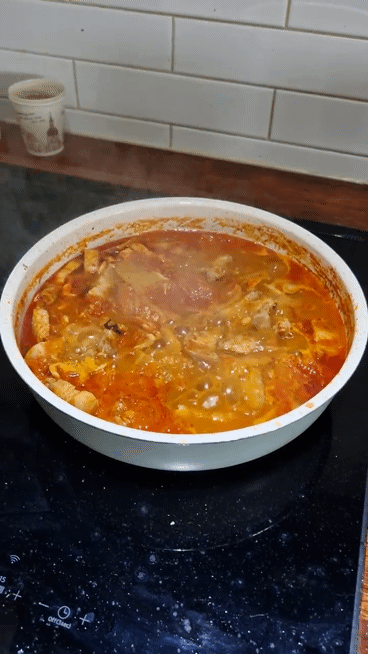 Authentic Korean Kimchi Jjigae (Kimchi Stew) boiling in a pot