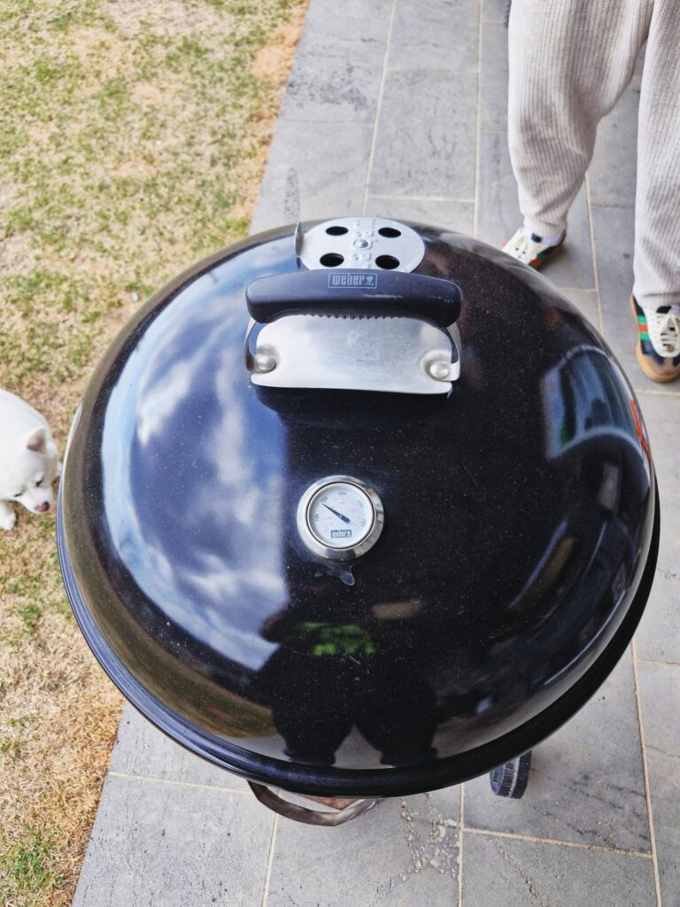 Smoking process of whole chicken in a Weber kettle grill