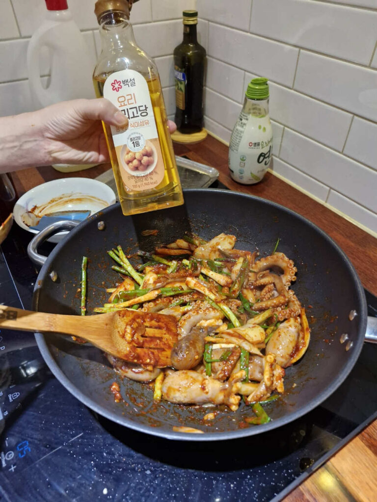 Tossing the octopus quickly over high heat