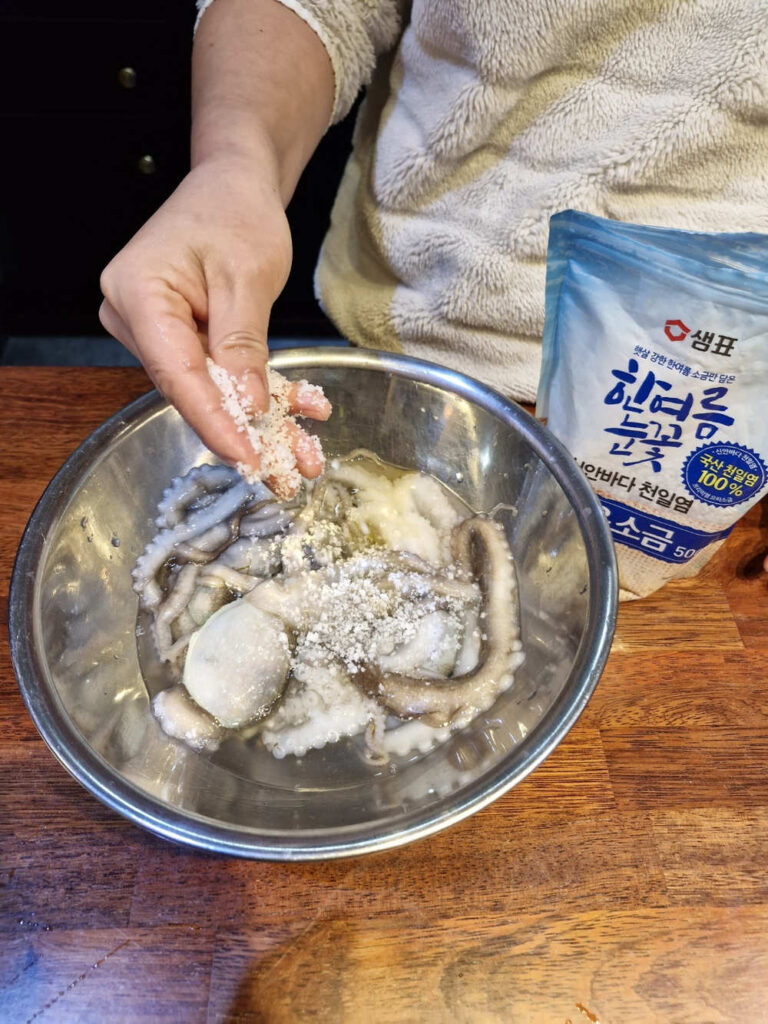 Scrubbing the octopus with coarse salt