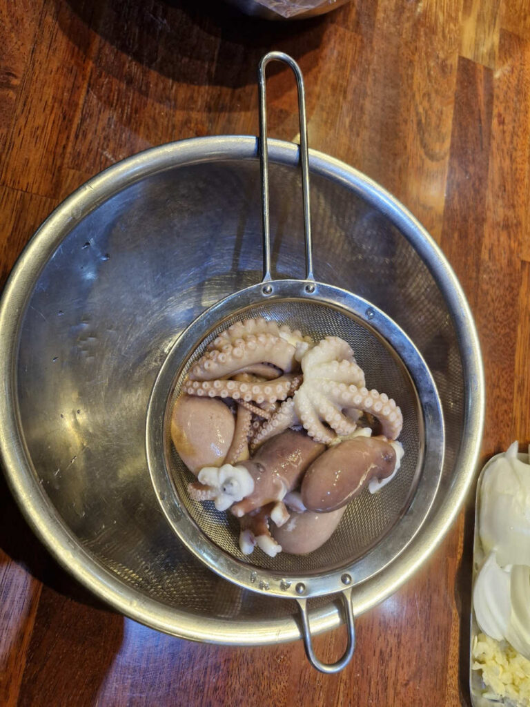 Drained octopus sitting in a colander