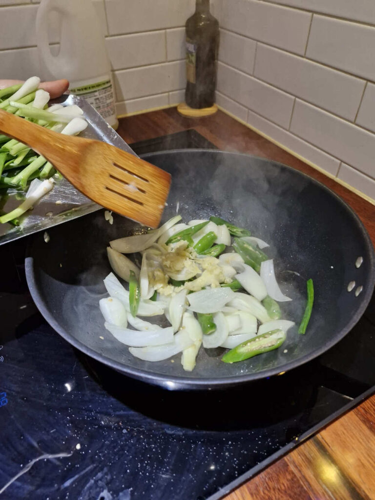 Onions and chilies sizzling in a pan