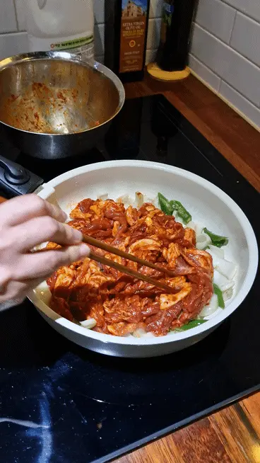Stir-frying all ingredients together over high heat in the wok