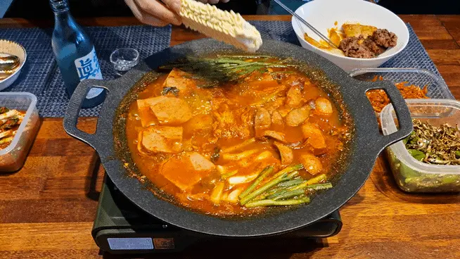 Adding instant ramen noodles to the boiling stew