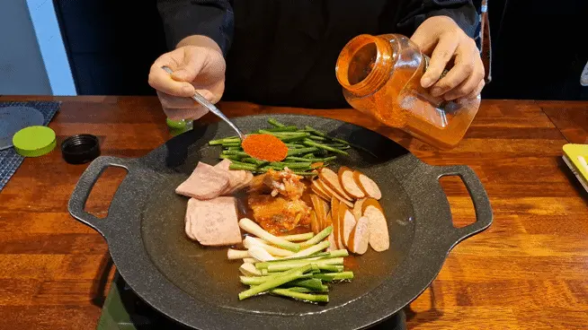 Adding 1 tablespoon of Korean red chili powder