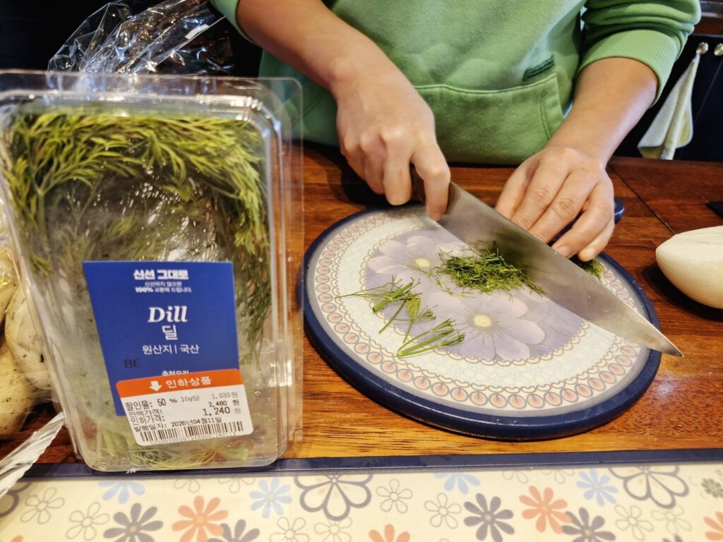 Chopping fresh dill finely for garnish