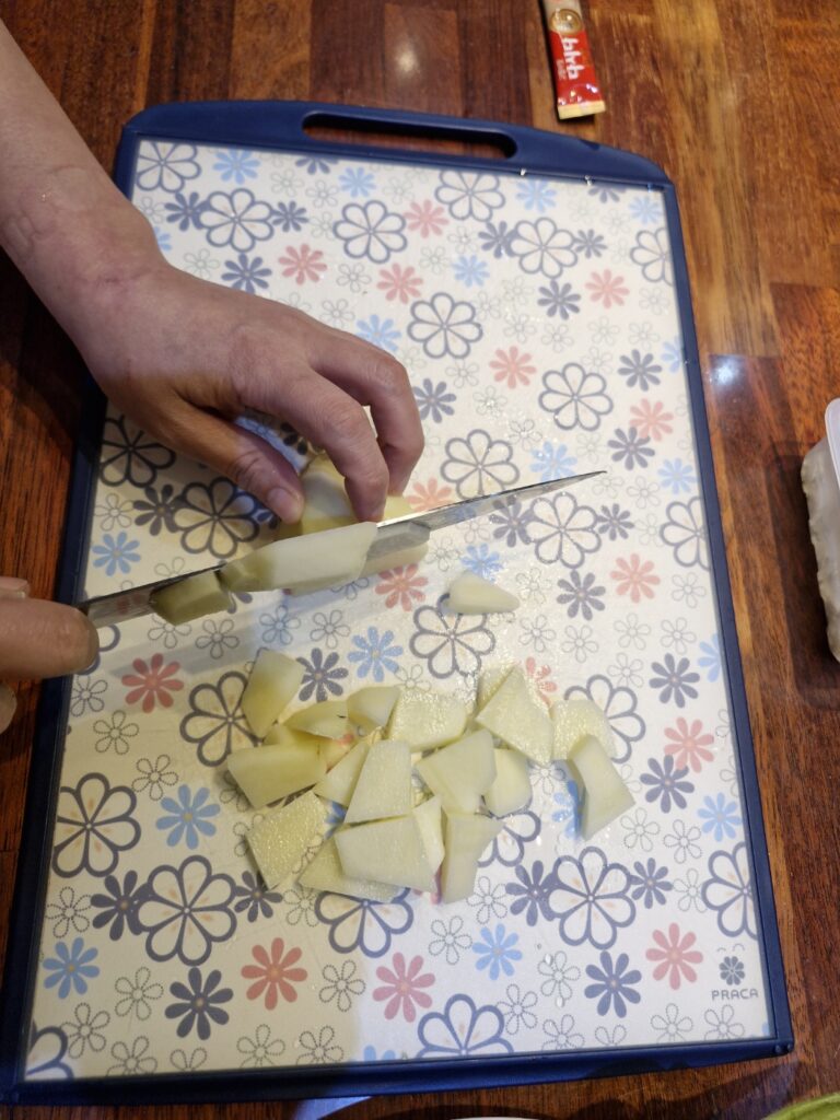 Chopping potatoes for Korean soybean paste stew