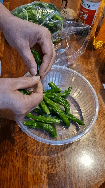 Removing the stems of shishito peppers