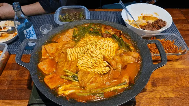 Cooking ramen noodles in the savory spicy broth