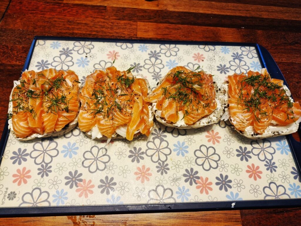 Adding chopped dill on top of the salmon sandwich
