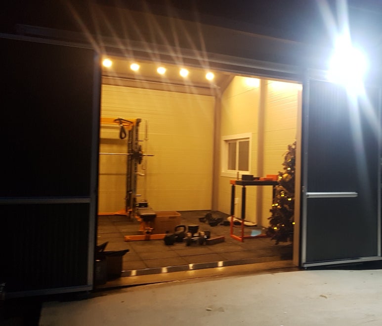 Cozy night view of a secluded warehouse home gym with warm lighting in Korea
