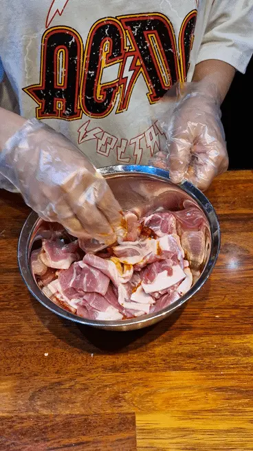 Hand mixing the pork and Jeyuk marinade thoroughly to ensure full coat