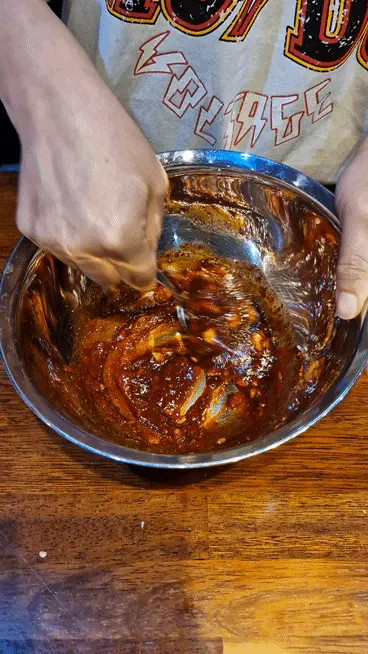 Mixing all seasoning ingredients together with a small whisk to create Jeyuk marinade