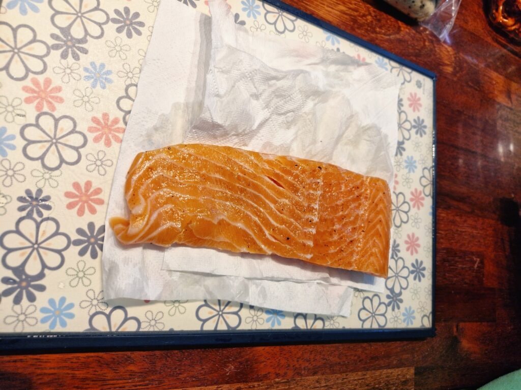 Rinsing excess salt off the cured salmon with water
