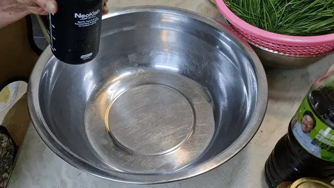 Adding sand lance fish sauce to the bowl