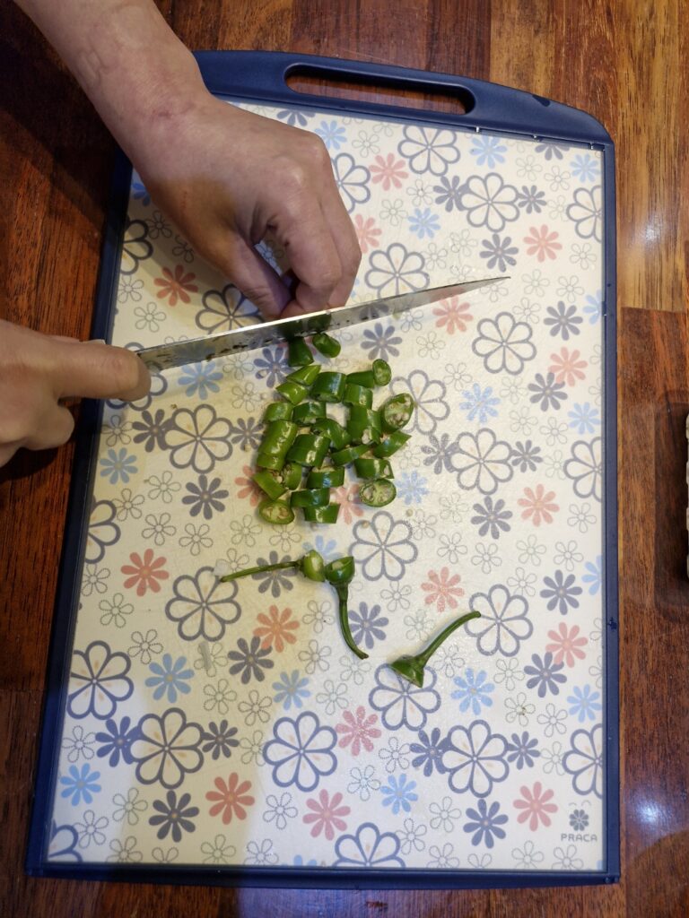 Slicing Korean green chilies for spice