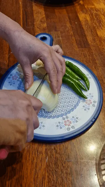 Slicing an onion on a wooden cutting board