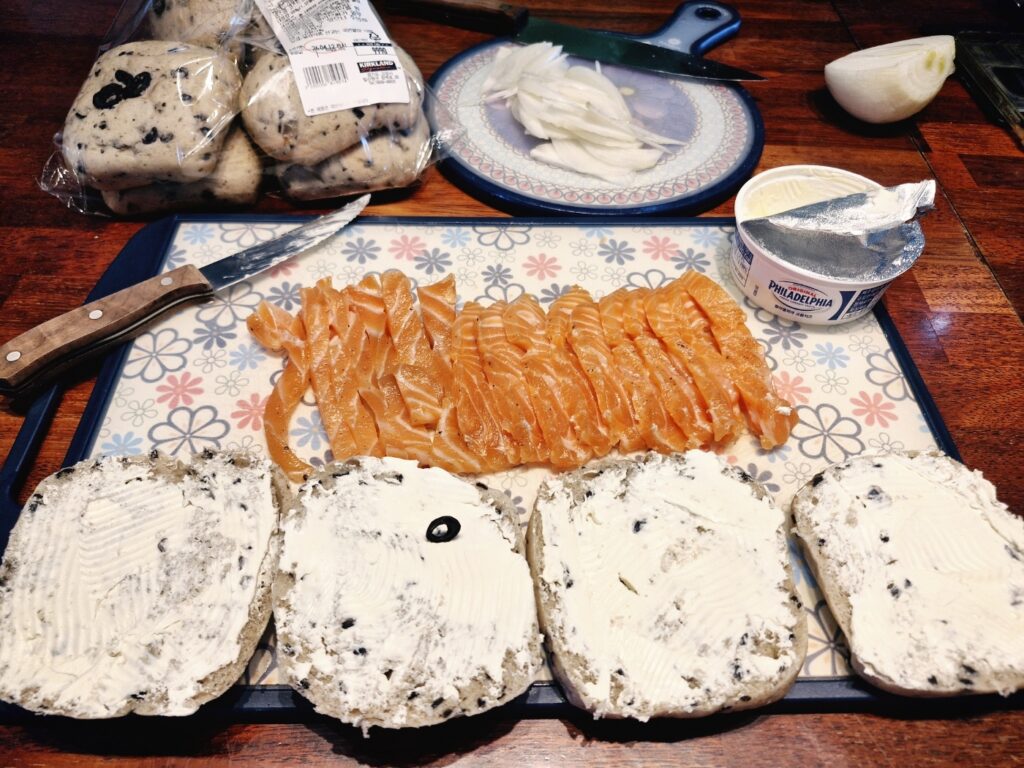 Placing thinly sliced onions on the cream cheese base
