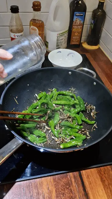 Turning off the heat and tossing with sesame seeds