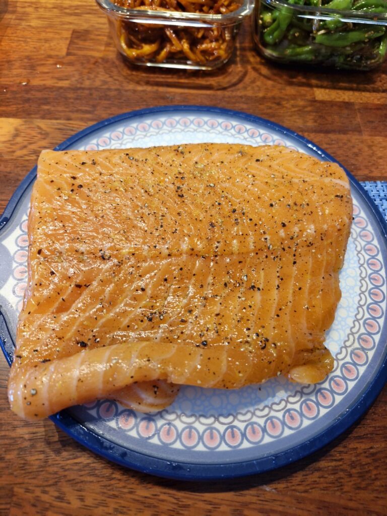 Removing plastic wrap from the cured salmon